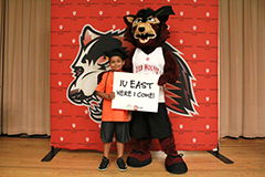 a student holds a sign with Rufus