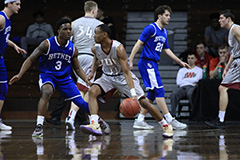 basketball player dribbles ball toward the defense