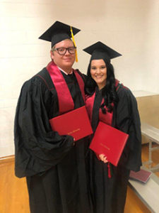 Chris Werking and Caitlin Boggs after commencement in grad caps and gowns