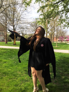 Female graduate tosses cap into air