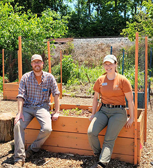 IU East Assistant Professor of Anthropology Aaron Comstock received an IU Women's Philanthropy Leadership Council grant for landscape management and continued public education to help preserve the historic site of the Guardian site near Lawrenceburg, Indiana. Comstock works on the project with Christina Emery, an ethnobotanist at the Archaeological Research Institute. They are sitting on a garden box at the site.