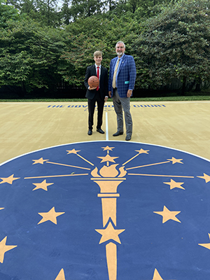 Photo of Cole Fosbrink with Gov Holcomb on the state symbol