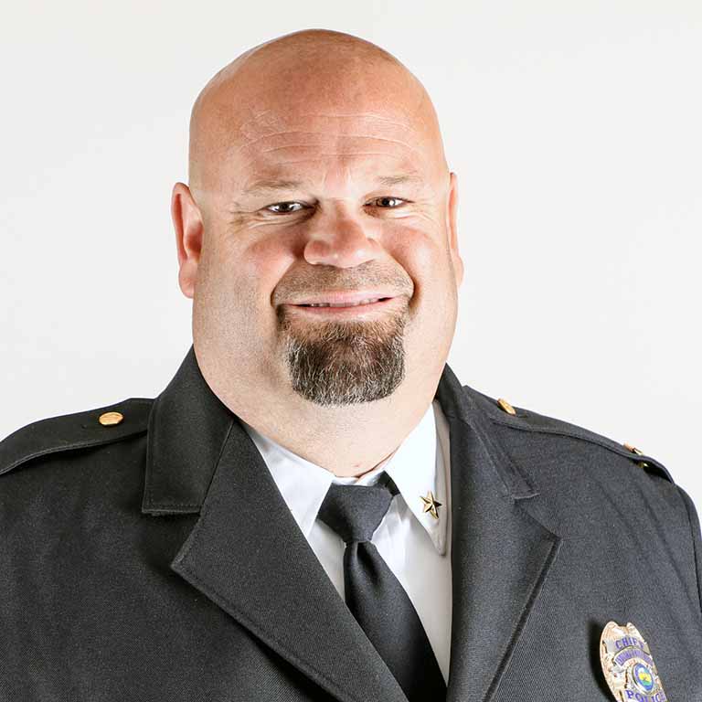 Portrait of Chief Dunning in uniform smiling.