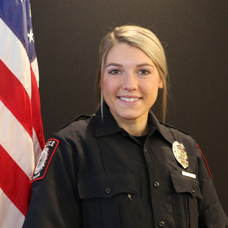 Portrait of Rikki Foust in uniform smiling.